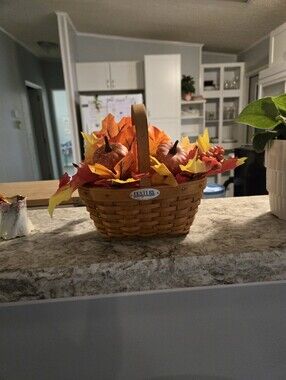 Longaberger woven basket with orange and yellow fall foliage